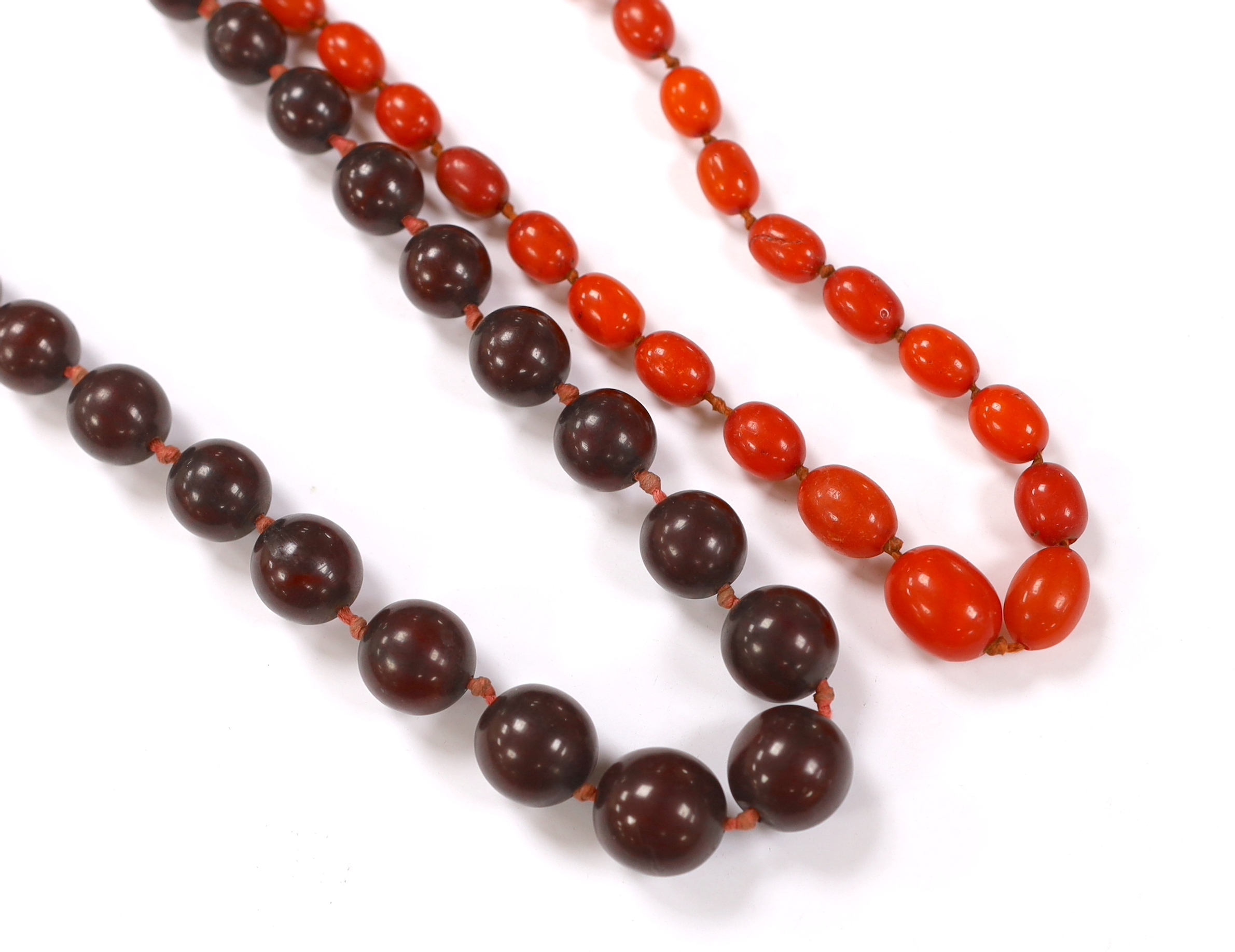 A single strand simulated cherry amber bead necklace, 70cm, gross weight 80 grams and one other necklace.